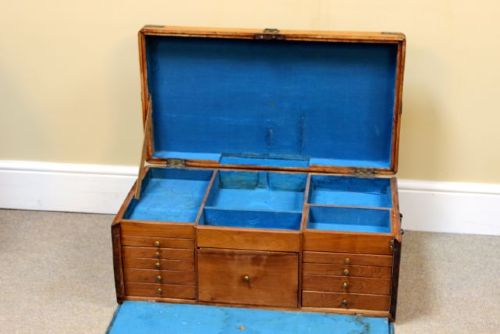 A nineteenth-century rectangular camphor wood chest featuring brass corner brackets, protective brass strapping, and a central keyhole escutcheon. View VI