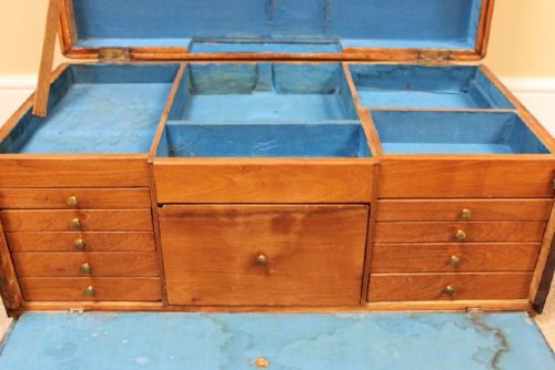 A nineteenth-century rectangular camphor wood chest featuring brass corner brackets, protective brass strapping, and a central keyhole escutcheon. View VII