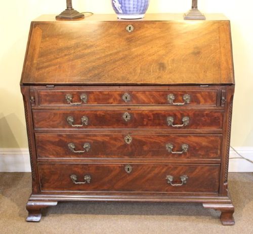An 18th-century Georgian flame mahogany bureau featuring a sloping fall-front lid, four graduated drawers with brass handles, and ogee bracket feet. View II