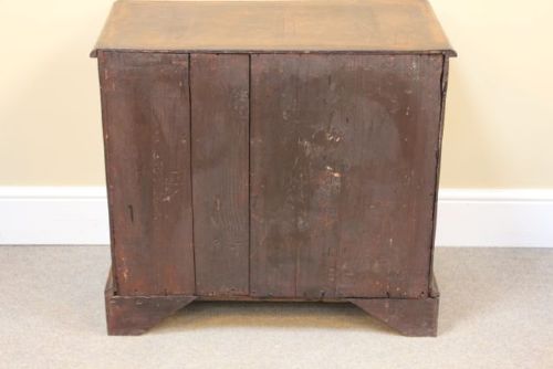 An 18th-century Georgian walnut chest of drawers featuring two short over two long drawers with brass drop handles and bracket feet. View IX