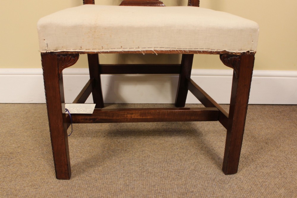 A dark mahogany Chippendale style dining chair with a pierced lattice splat back, neutral upholstered seat, and square legs with stretchers. View III