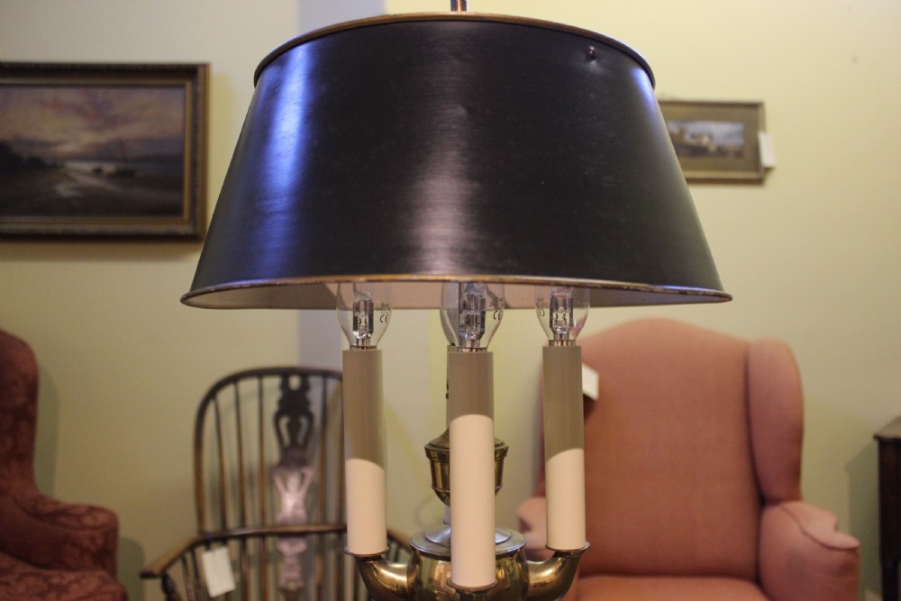 A four-branch brass bouillotte lamp featuring an adjustable dark metal shade, candle-style sleeves, and a decorative loop finial. View IV