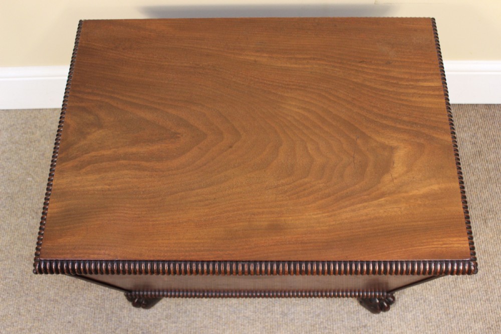 A nineteenth-century mahogany sarcophagus-shaped cellarette featuring reeded moulding borders, a keyhole escutcheon, and carved paw feet. View II