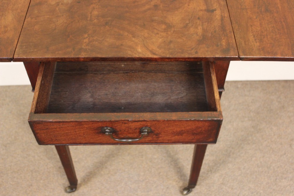 An 18th-century mahogany Pembroke side table featuring drop leaves, a single front drawer with brass pull, and tapered square legs on brass castors. View III