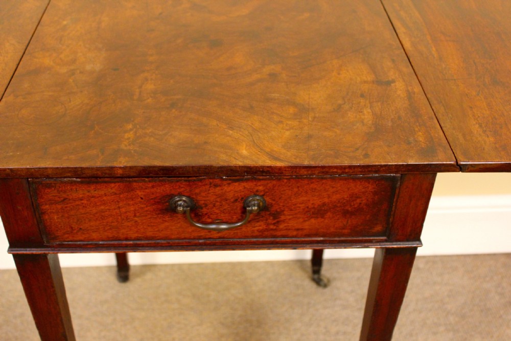 An 18th-century mahogany Pembroke side table featuring drop leaves, a single front drawer with brass pull, and tapered square legs on brass castors. View IV