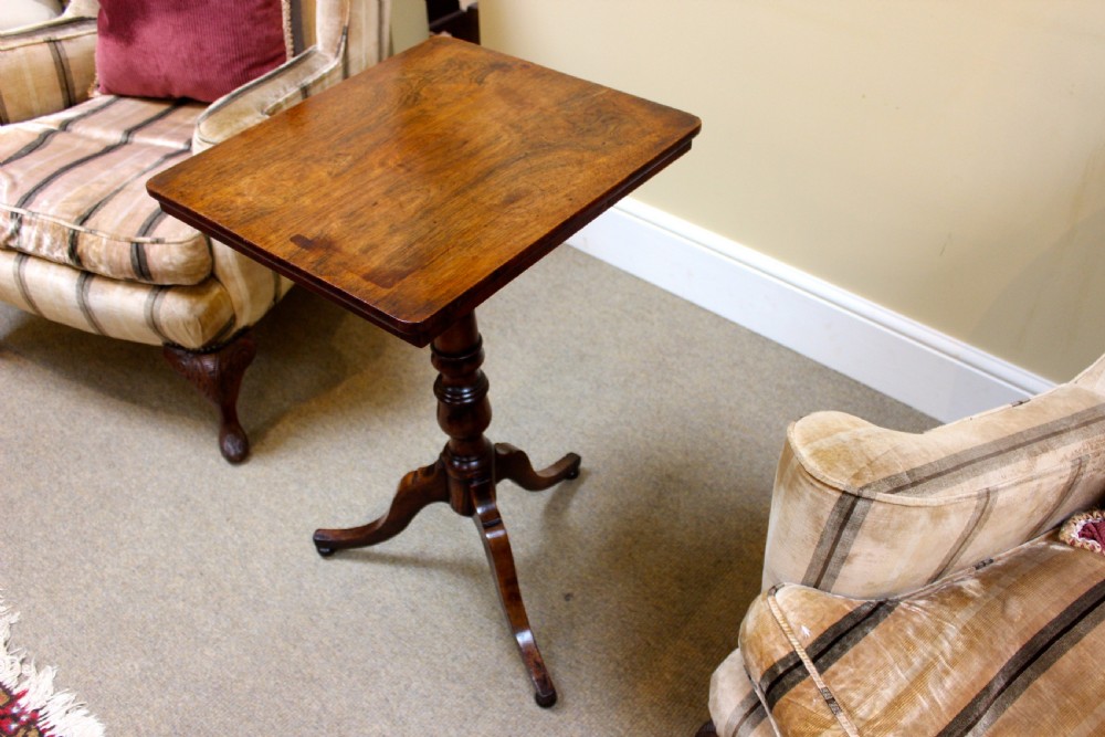 A nineteenth-century dark rosewood tripod table featuring a square top with rounded corners, a central turned pedestal, and three splayed feet. View IV