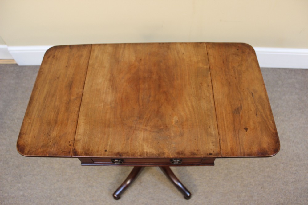 A 19th-century mahogany drop-flap side table featuring an open drawer, a turned central pedestal, and four splayed legs. View IV