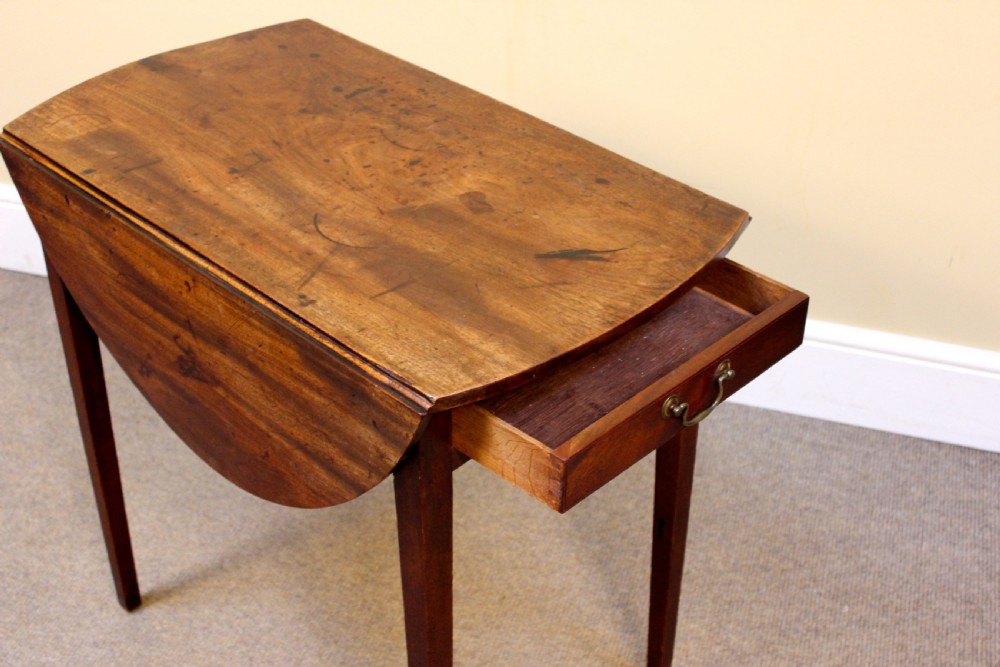 A rectangular Georgian mahogany Pembroke table featuring two drop leaves and tapered legs stands against a neutral background. View IV