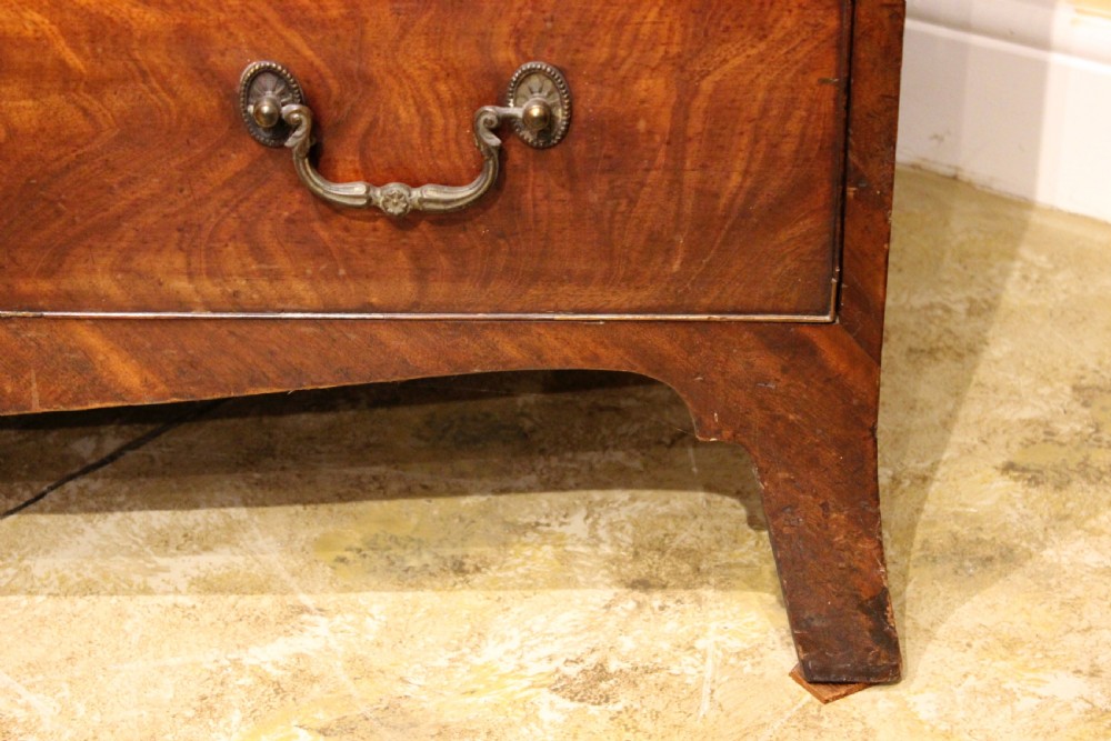 A late 18th-century mahogany secretaire chest on chest featuring flame mahogany veneer, brass swan-neck handles, a decorative blind-fret cornice, and bracket feet. View VII