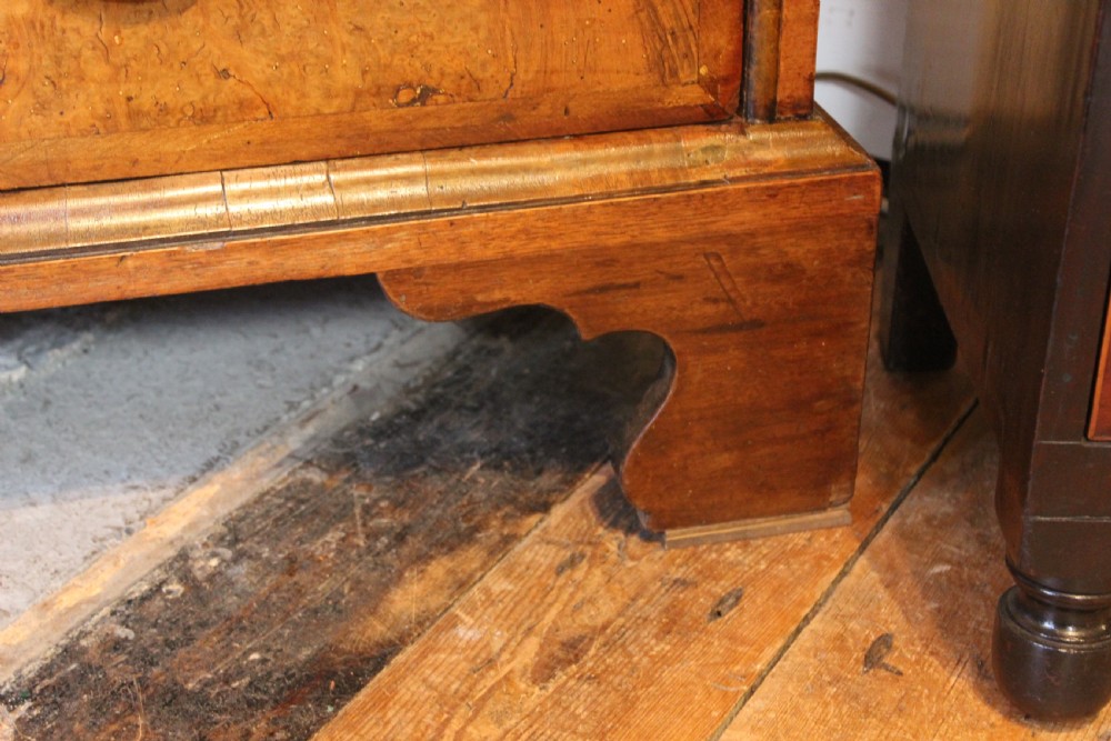 An early eighteenth-century walnut escritoire featuring a fall-front writing upper section with cushion moulding over a chest of three long drawers on bracket feet. View VIII