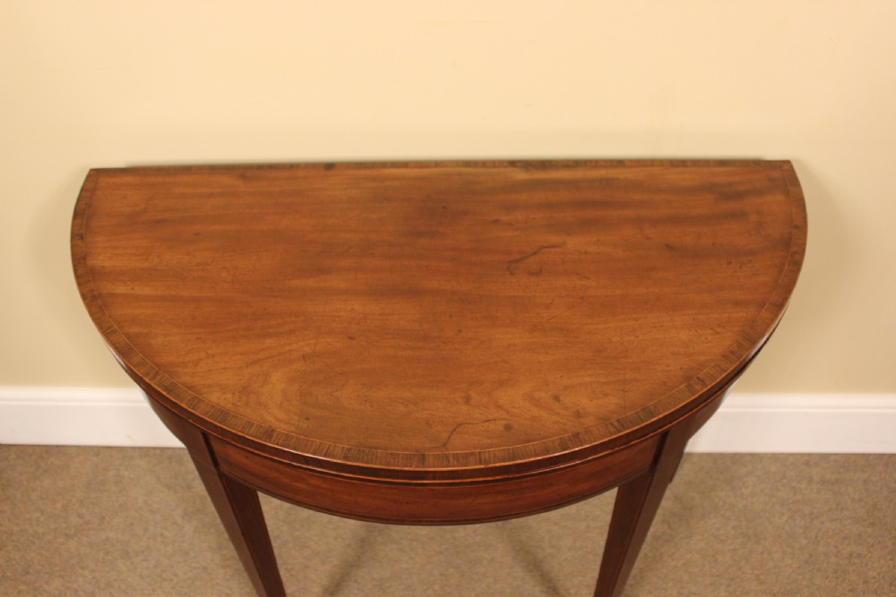 A nineteenth-century mahogany demi-lune card table featuring linear string inlay and square tapered legs. View III