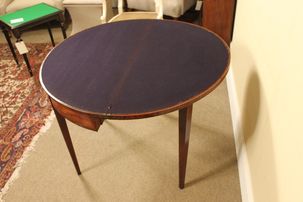 A nineteenth-century mahogany demi-lune card table featuring linear string inlay and square tapered legs. View VI