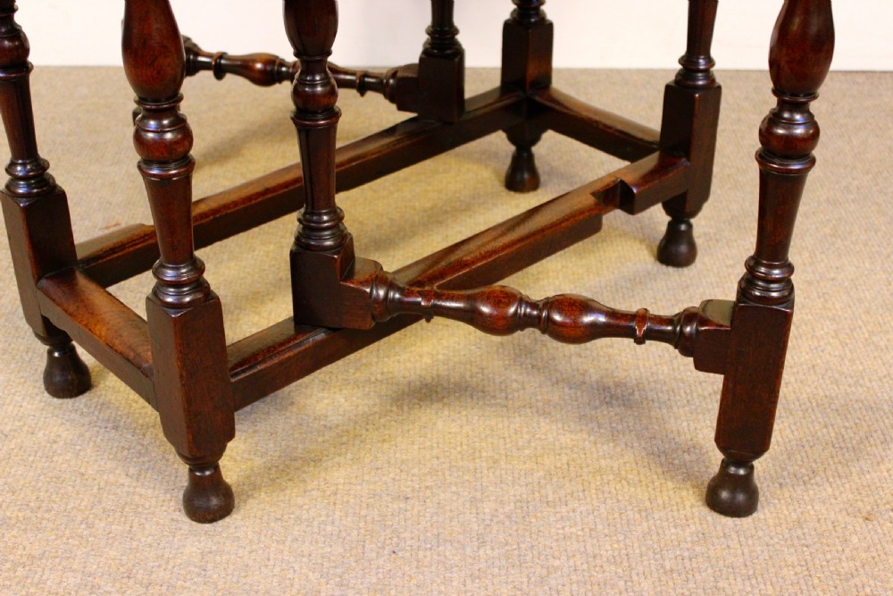 An early eighteenth-century walnut gate leg table featuring baluster-turned legs, a stretcher base, a single drawer, and two drop leaves. View IV