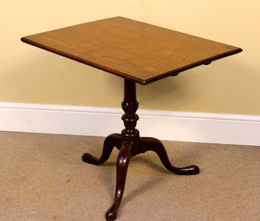 An early nineteenth-century mahogany tilt-top tripod table shown in the upright position, featuring a turned central column and three cabriole legs. View II