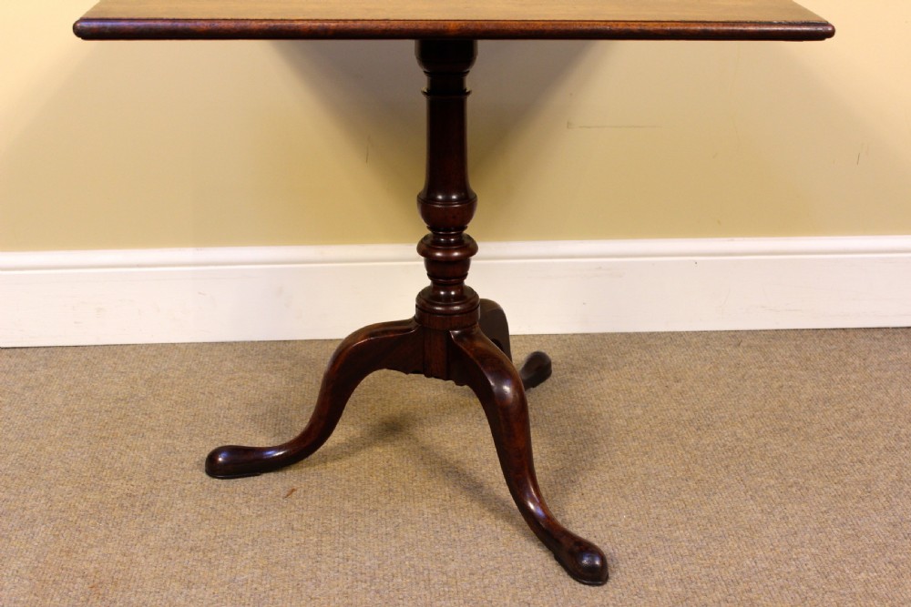 An early nineteenth-century mahogany tilt-top tripod table shown in the upright position, featuring a turned central column and three cabriole legs. View III