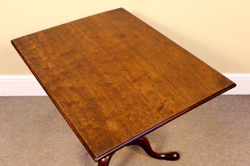 An early nineteenth-century mahogany tilt-top tripod table shown in the upright position, featuring a turned central column and three cabriole legs. View V