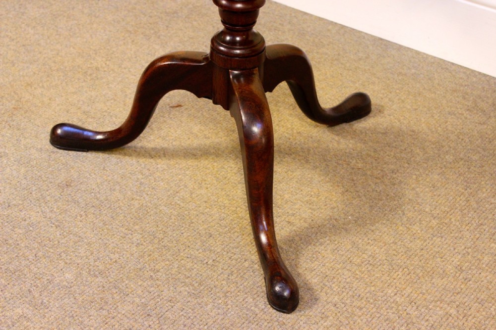 An early nineteenth-century mahogany tilt-top tripod table shown in the upright position, featuring a turned central column and three cabriole legs. View VI