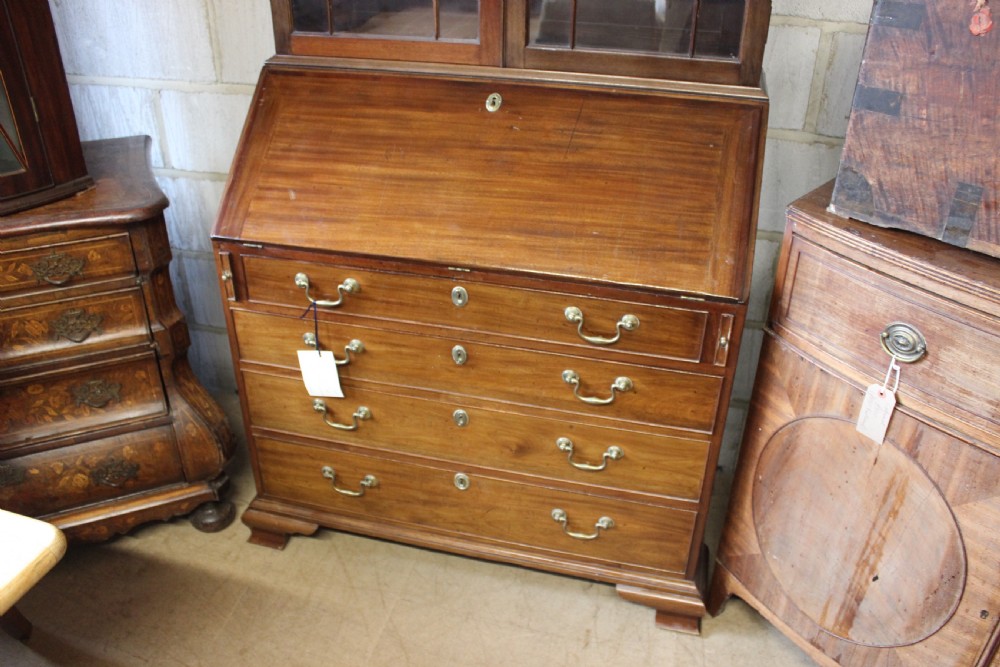 A 19th-century mahogany bureau bookcase with two astragal glazed doors above a fall-front slanted writing desk and four long graduated drawers. View III