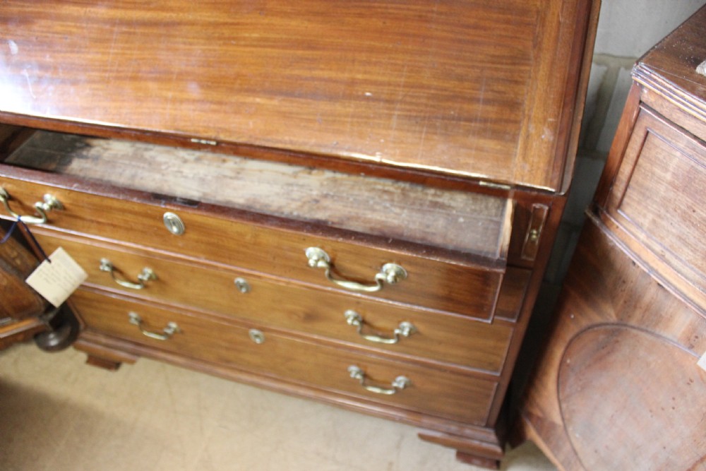 A 19th-century mahogany bureau bookcase with two astragal glazed doors above a fall-front slanted writing desk and four long graduated drawers. View IV