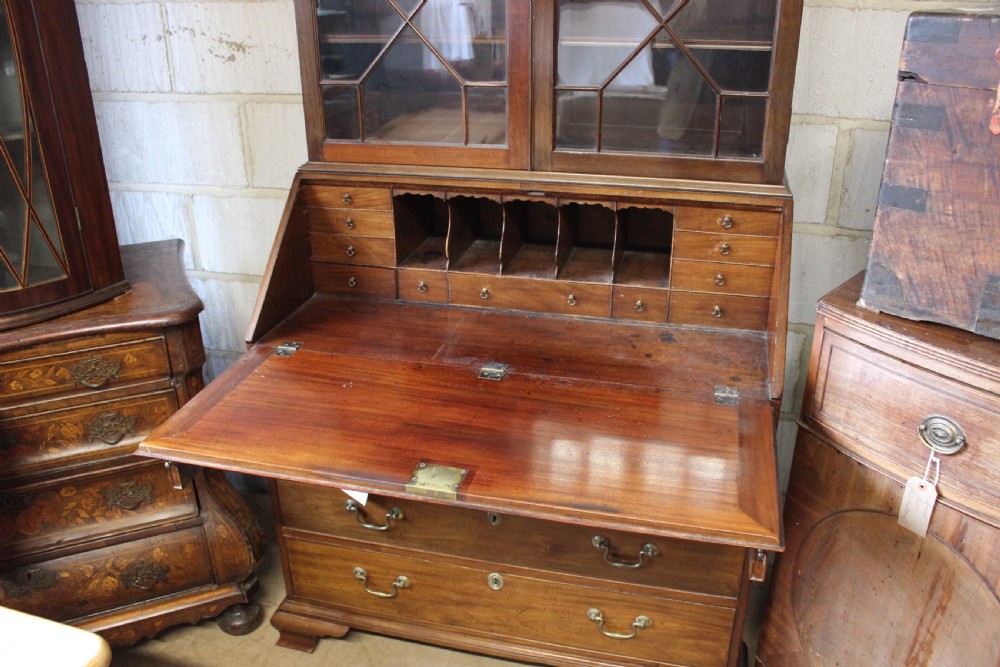 A 19th-century mahogany bureau bookcase with two astragal glazed doors above a fall-front slanted writing desk and four long graduated drawers. View V