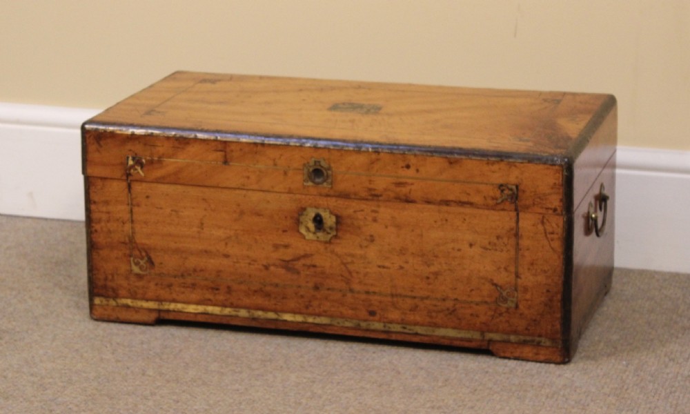 A small 19th-century rectangular camphor wood chest featuring brass inlay line work, side carrying handles, and a central brass keyhole escutcheon.