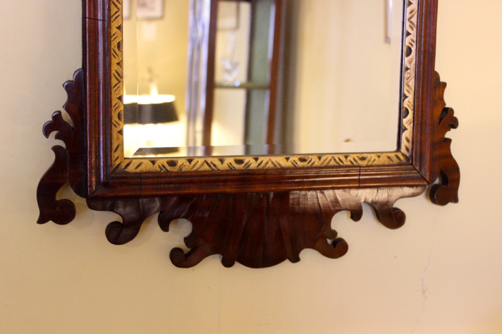 A 19th-century dark walnut fretwork wall mirror featuring scrolled timber edges, a gilded inner slip, and a carved gilt eagle crest at the top. View IV