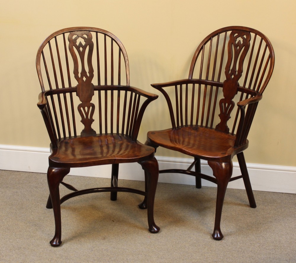 A pair of nineteenth-century yew and elm Windsor armchairs featuring steam-bent hoop backs, pierced central splats, contoured seats, and cabriole front legs. View II