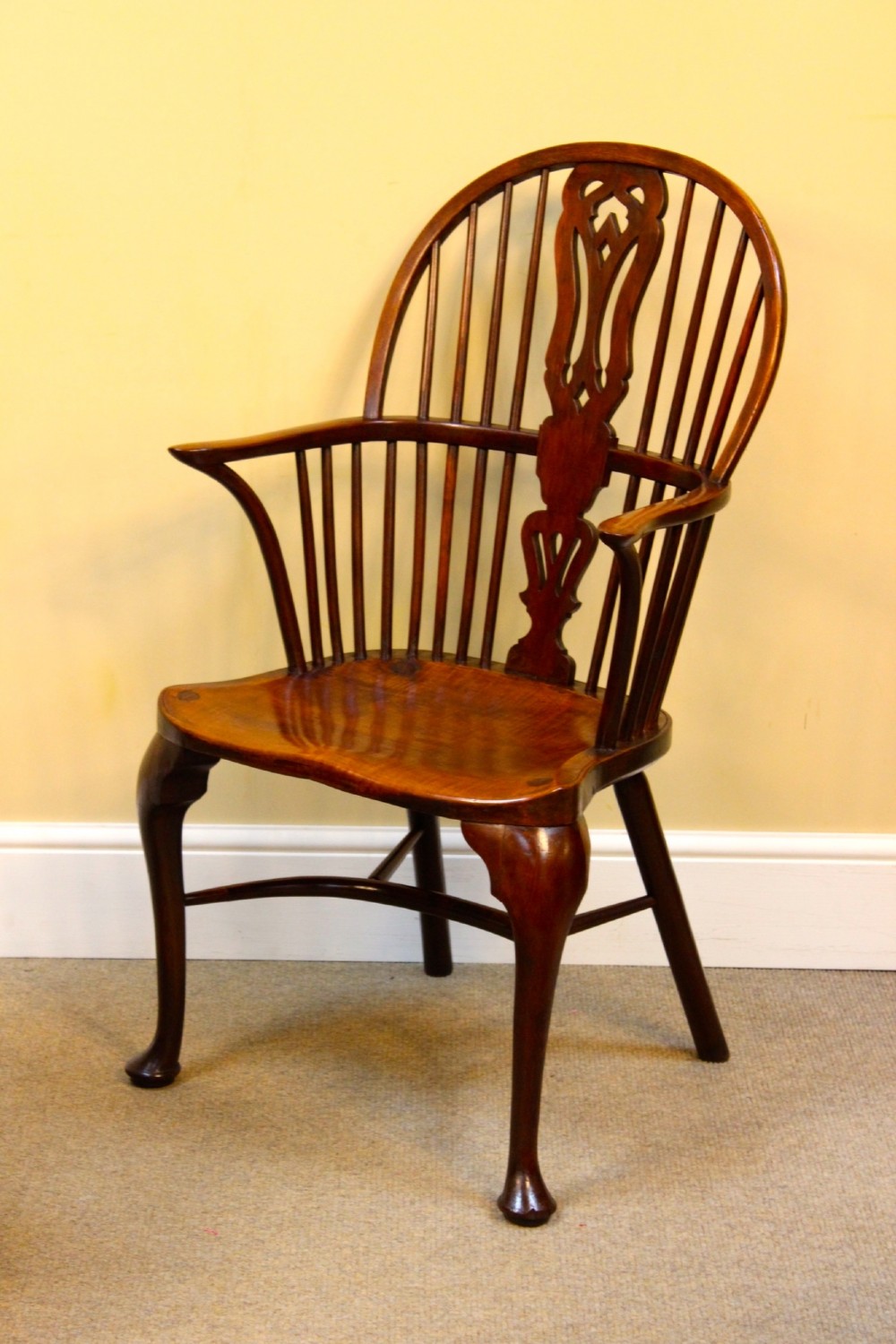 A pair of nineteenth-century yew and elm Windsor armchairs featuring steam-bent hoop backs, pierced central splats, contoured seats, and cabriole front legs. View IV
