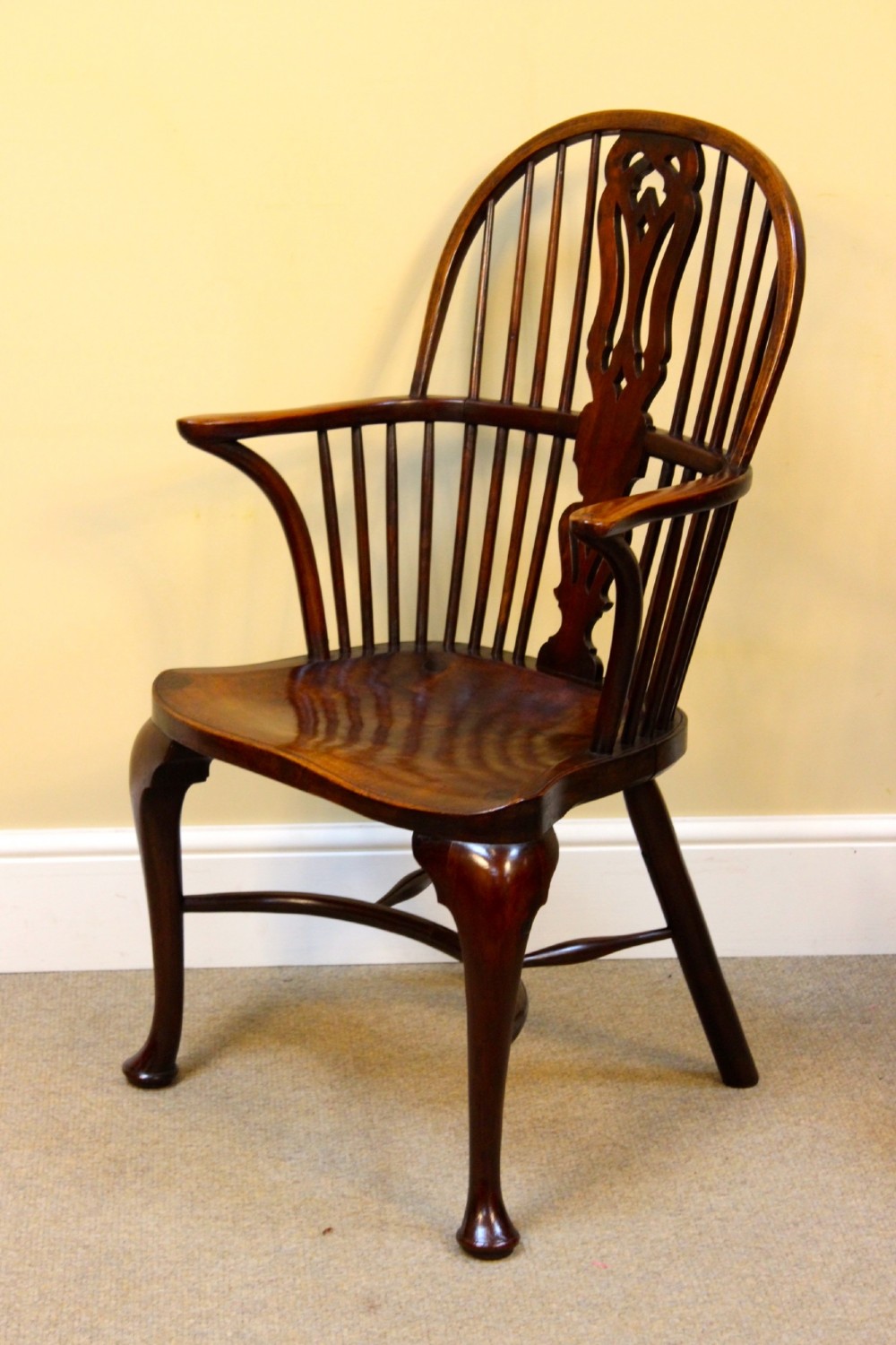 A pair of nineteenth-century yew and elm Windsor armchairs featuring steam-bent hoop backs, pierced central splats, contoured seats, and cabriole front legs. View V