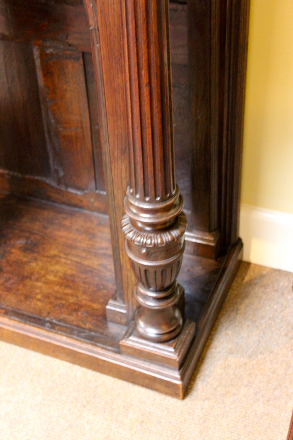 An 18th-century dark oak side table featuring a single top drawer with brass handles above twin open arched bays framed by fluted columns. View VI