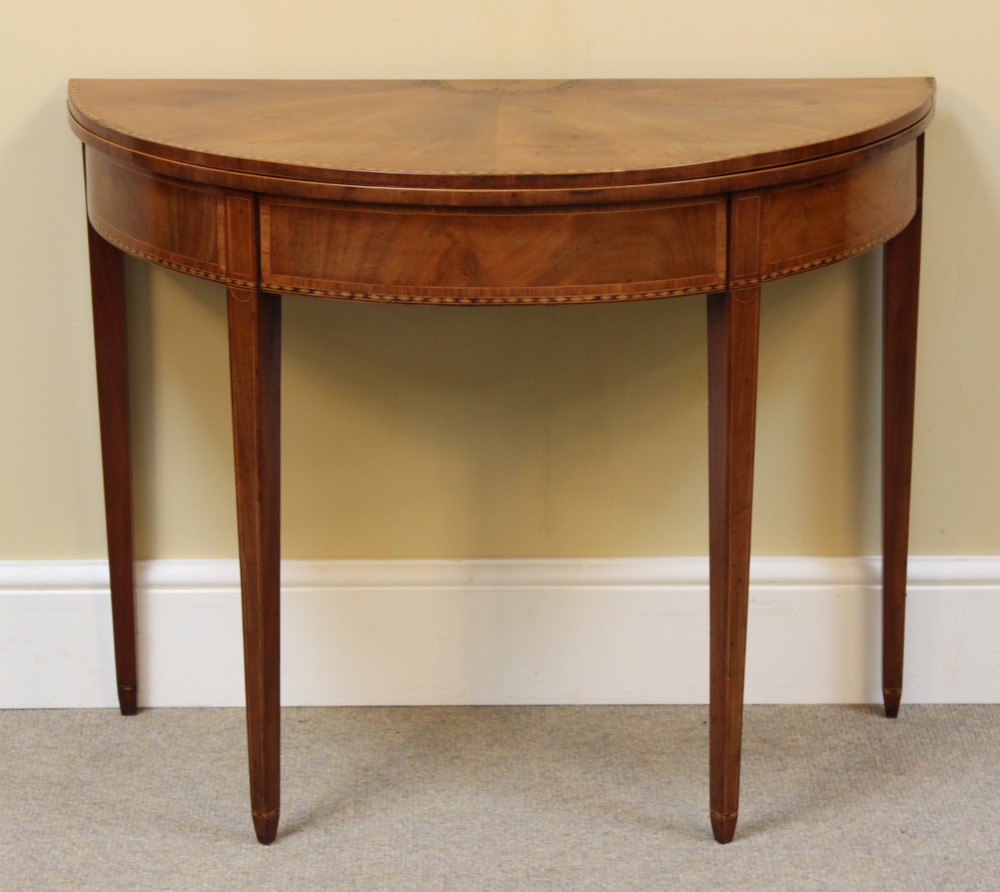 A 19th-century mahogany and fruitwood demi-lune card table featuring fan veneer inlays on the folding top and four tapered legs. View II