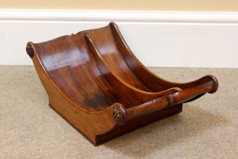 A crescent-shaped Georgian mahogany cheese coaster with carved floral rosettes on the scrolled terminals. View III