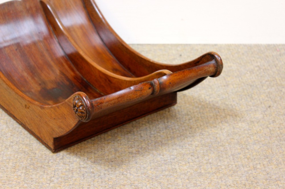 A crescent-shaped Georgian mahogany cheese coaster with carved floral rosettes on the scrolled terminals. View V