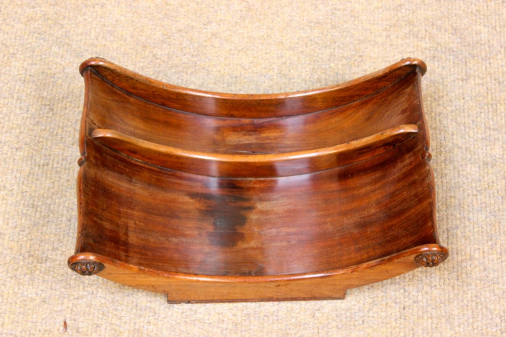 A crescent-shaped Georgian mahogany cheese coaster with carved floral rosettes on the scrolled terminals. View VI