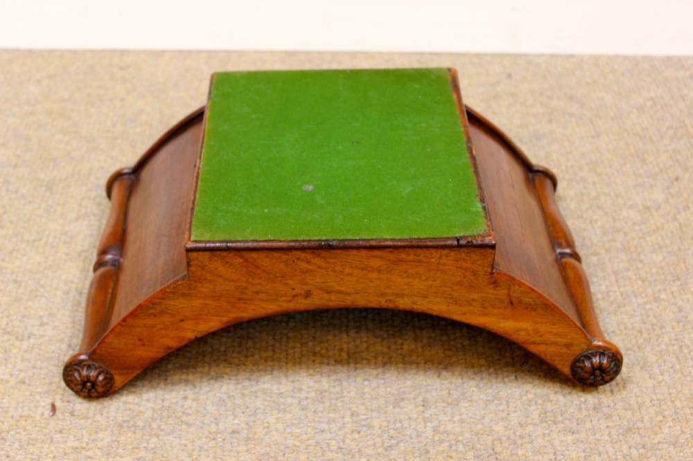A crescent-shaped Georgian mahogany cheese coaster with carved floral rosettes on the scrolled terminals. View VII
