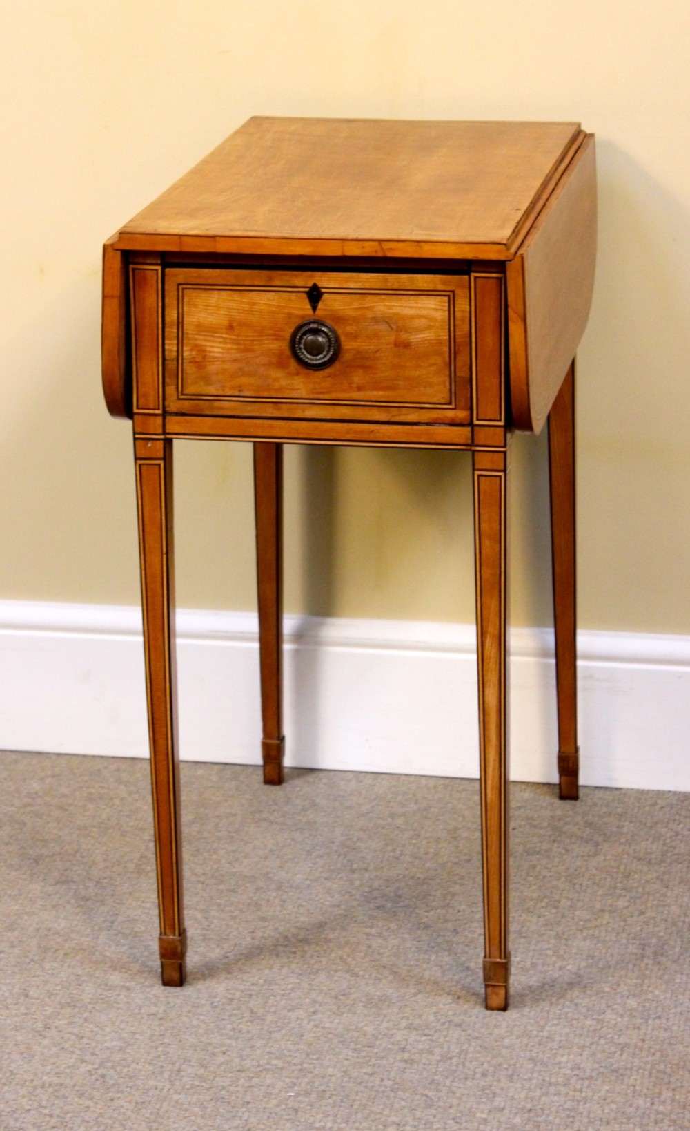 A Regency satinwood drop flap side table featuring inlaid stringing, a single drawer with a brass knob, and square tapered legs. View III