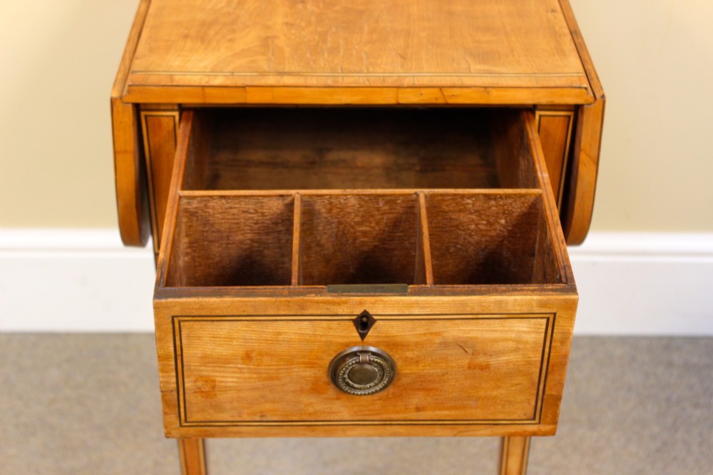 A Regency satinwood drop flap side table featuring inlaid stringing, a single drawer with a brass knob, and square tapered legs. View IV