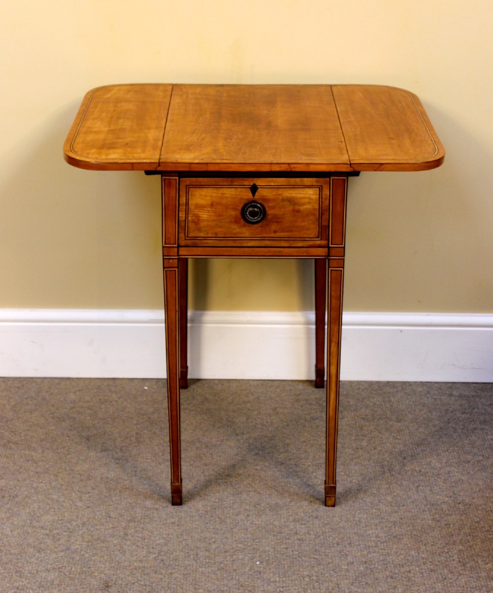 A Regency satinwood drop flap side table featuring inlaid stringing, a single drawer with a brass knob, and square tapered legs. View VI
