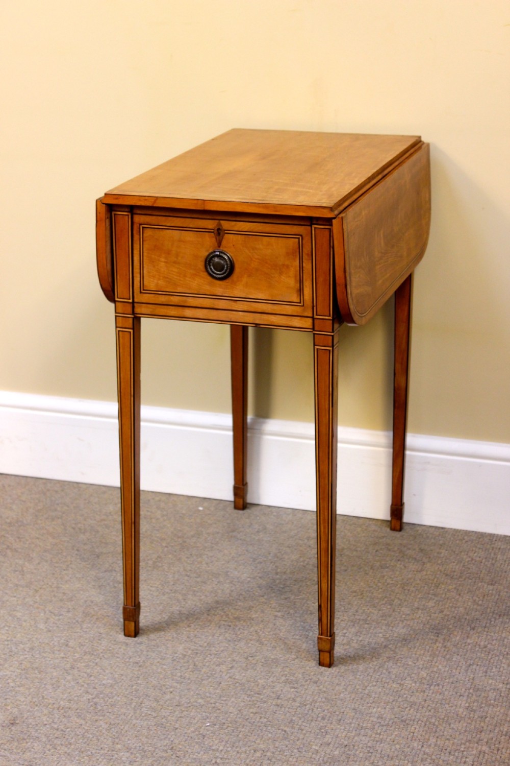 A Regency satinwood drop flap side table featuring inlaid stringing, a single drawer with a brass knob, and square tapered legs. View VIII