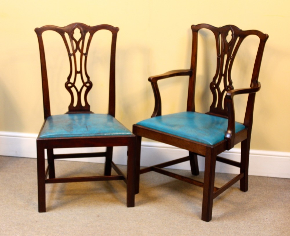 A pair of 19th-century Chippendale style mahogany dining chairs featuring carved pierced back splats, square legs with stretchers, and bright blue leather drop-in seats. View II