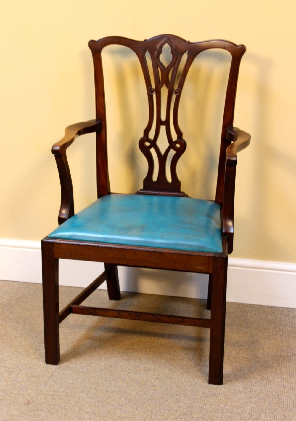 A pair of 19th-century Chippendale style mahogany dining chairs featuring carved pierced back splats, square legs with stretchers, and bright blue leather drop-in seats. View III