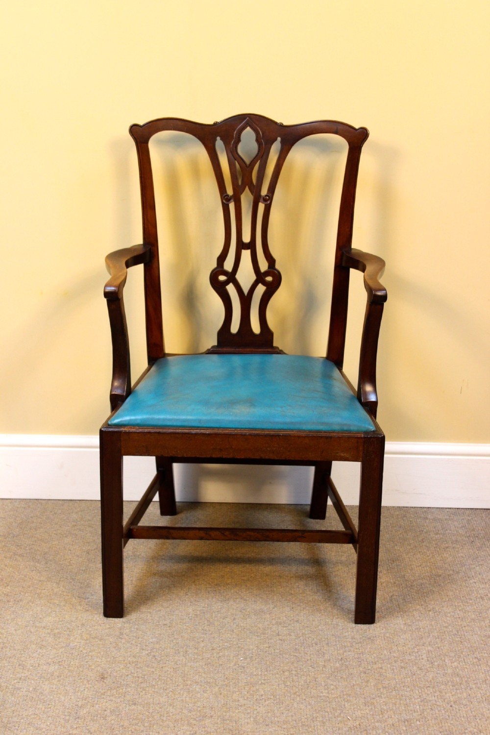 A pair of 19th-century Chippendale style mahogany dining chairs featuring carved pierced back splats, square legs with stretchers, and bright blue leather drop-in seats. View IV