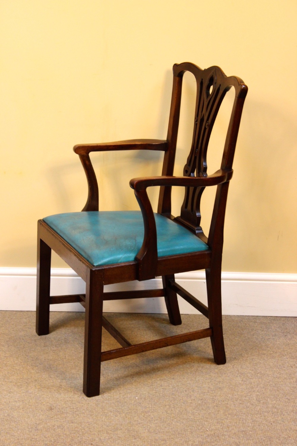 A pair of 19th-century Chippendale style mahogany dining chairs featuring carved pierced back splats, square legs with stretchers, and bright blue leather drop-in seats. View VI