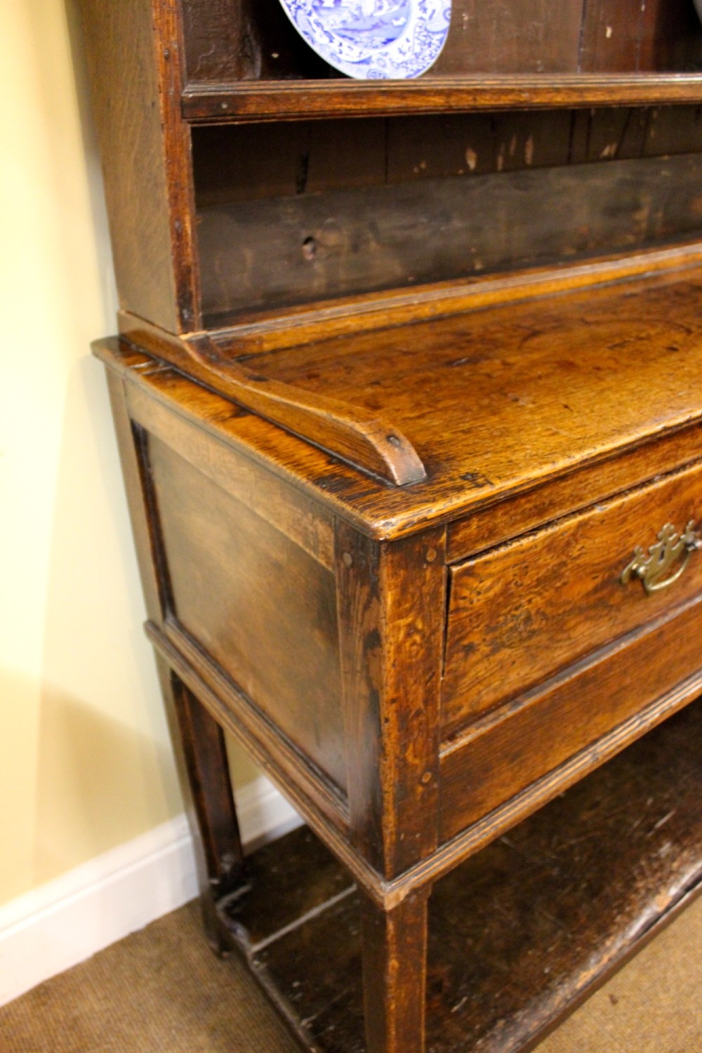 An 18th-century dark oak dresser featuring a multi-tier open plate rack above a drawer and cupboard base with a lower pot board. View IV