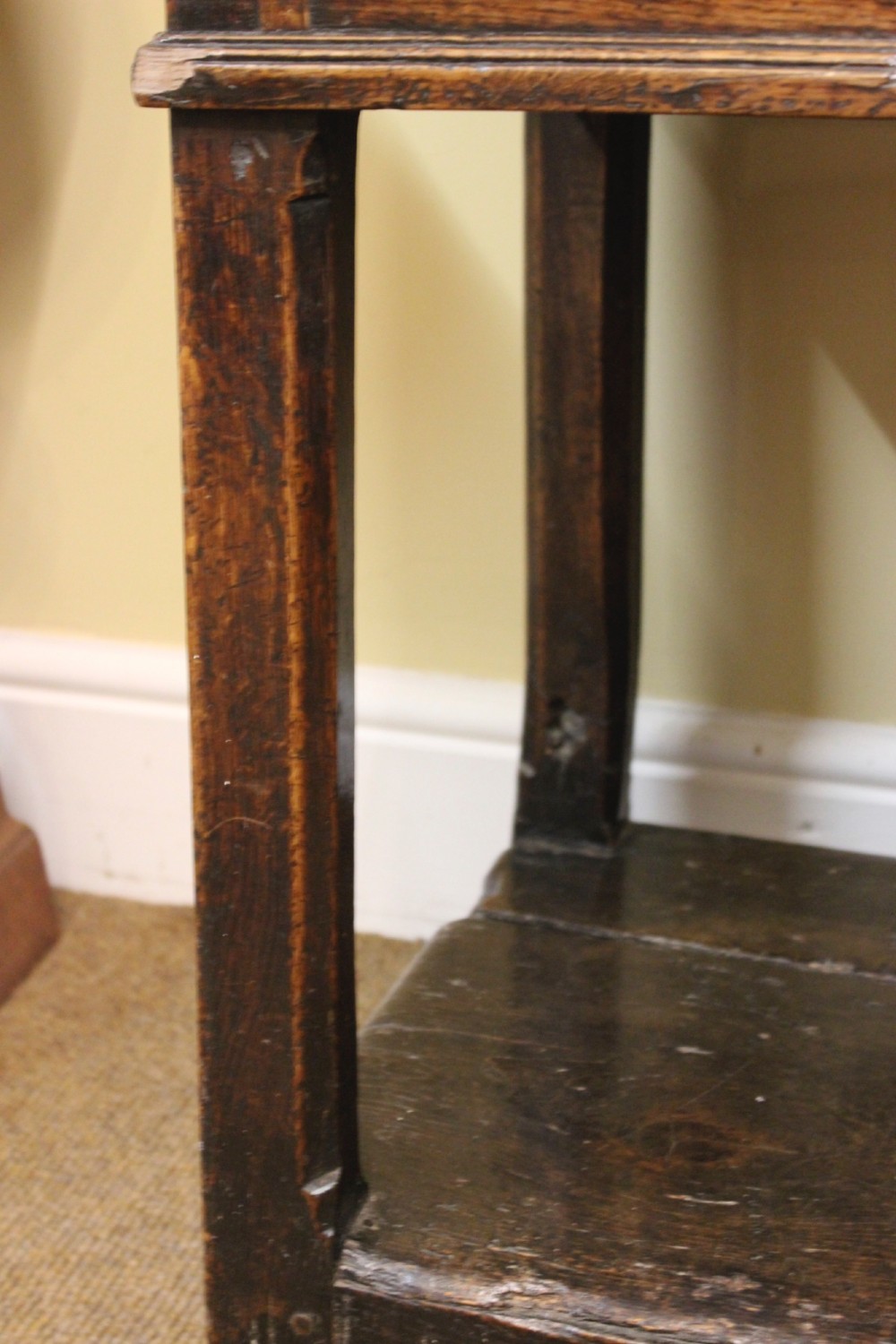 An 18th-century dark oak dresser featuring a multi-tier open plate rack above a drawer and cupboard base with a lower pot board. View X