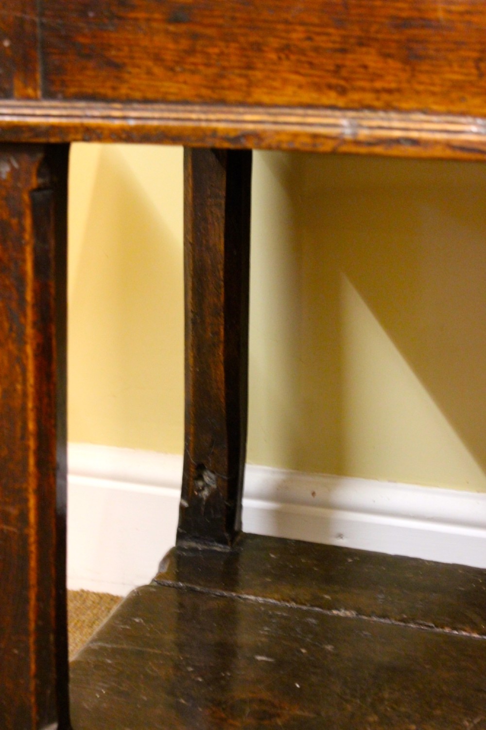 An 18th-century dark oak dresser featuring a multi-tier open plate rack above a drawer and cupboard base with a lower pot board. View XI