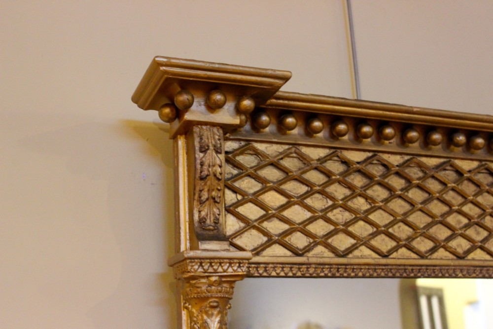 A tall 19th-century giltwood pier mirror featuring fluted side pilasters, a ball-moulded cornice, and a lattice pattern top frieze. View IV