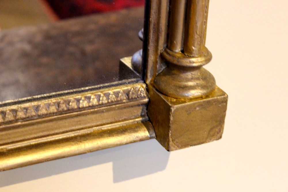 A tall 19th-century giltwood pier mirror featuring fluted side pilasters, a ball-moulded cornice, and a lattice pattern top frieze. View VI