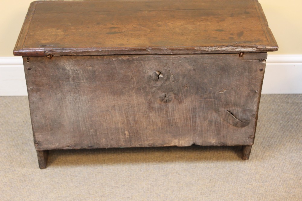 A 17th-century dark oak six-plank coffer featuring a hinged rectangular lid, hand-forged iron lockplate, and slab sides. View VIII