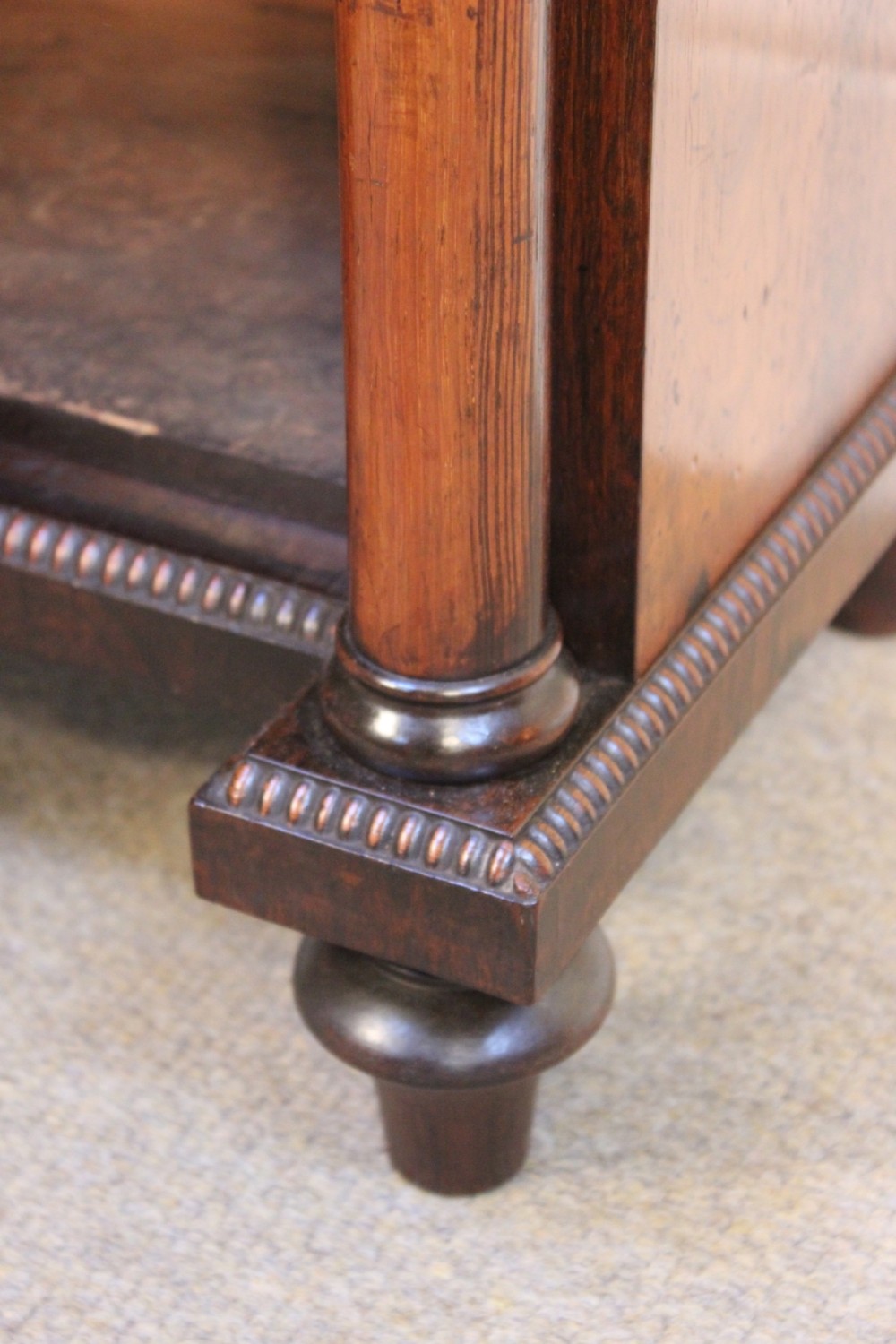 A 19th-century rosewood pier cabinet featuring a single door with a brass wire grille over pleated fabric, flanked by turned columns. View VII
